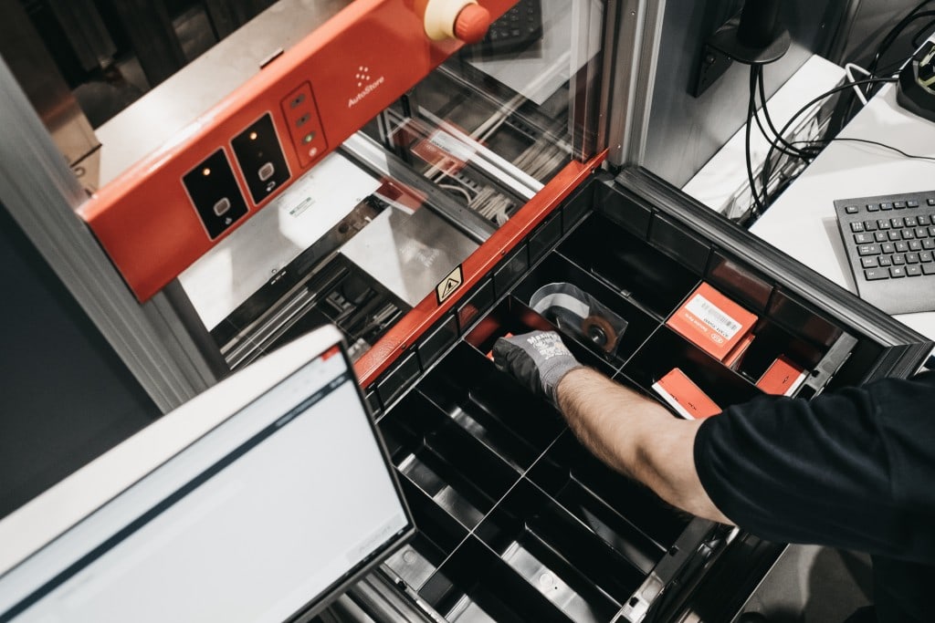 Warehouse worker at AutoStore Picking Station.