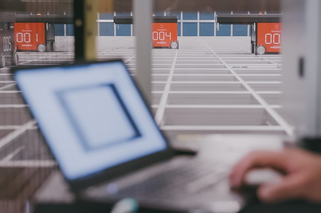 A close-up of a laptop with the eManager software controlling and optimising the AutoStore-system and robots.