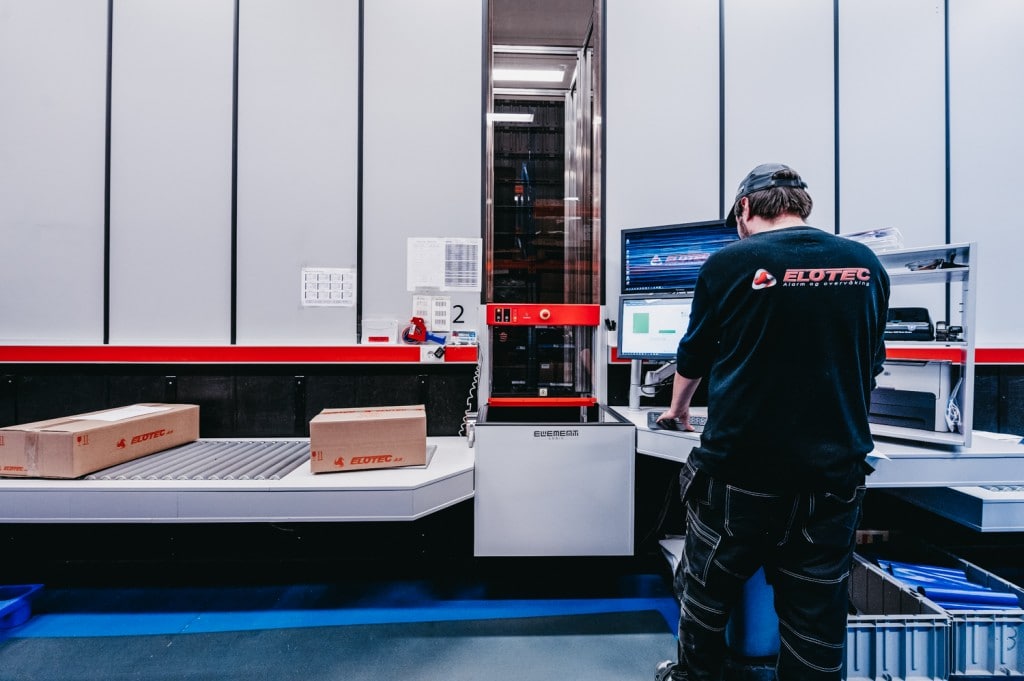 A worker is handling the orders from AutoStore.