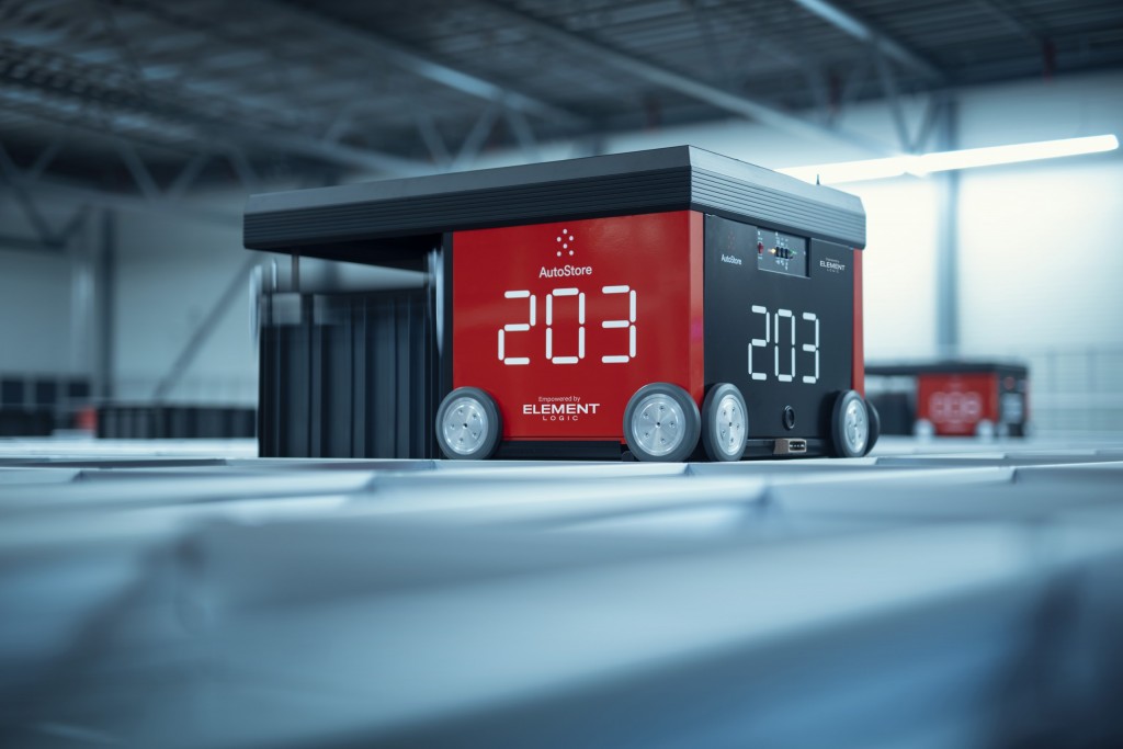 Two red AutoStore robots on top of an aluminum grid.